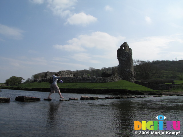 SX05345 Jenni crossing stepping stones by Ogmore Castle